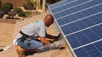 Installing solar panel pigeon screening under solar panels of residential solar panels on roof